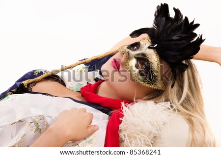 Portrait of the pretty girl in mask and red scarf