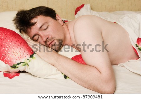 Picture with a man sleeping in bed