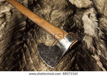 Still life with  medieval axe on a wolf fur