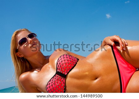 A girl with a beautiful slender figure against the sea