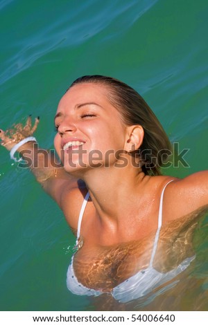 stock photo The sexual young blonde girl with a beautiful body swims in 
