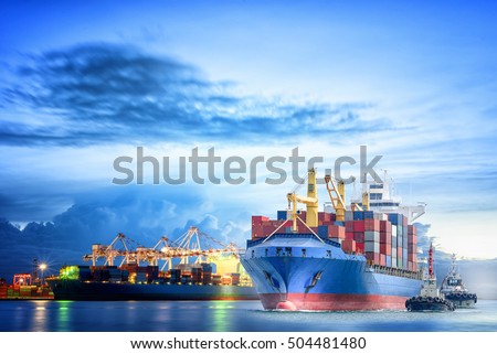 Logistics and transportation of international container cargo ship with ports crane bridge in harbor at dusk for logistics import export background and transportation industry