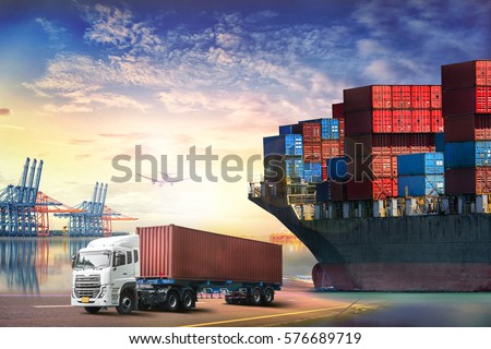 Logistics import export background and transport industry of Container truck and Cargo ship with working crane bridge in shipyard at sunset sky