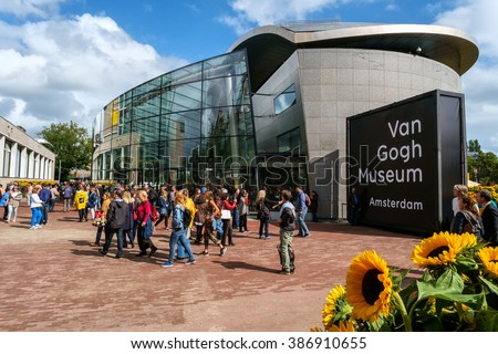 Amsterdam, the Netherlands, September 5, 2015: crowd in front of the new wing of the Van Gogh Museum with sunflowers in the foreground