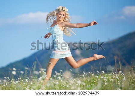 Young beautiful girl resting in flower field