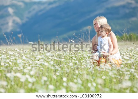Smiling mother and little baby on nature. Happy people outdoors