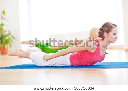 Group of sport women in the gym centre doing stretching fitness exercise. Yoga