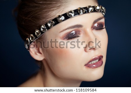 Glamorous female portrait close-up. Fashion evening elegance shine to the eyes and lips. Eye makeup model. Cosmetics and makeup