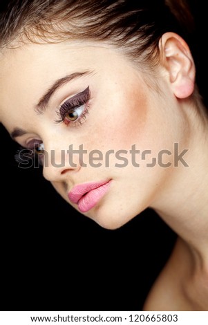 Glamourous closeup female portrait. Fashion evening elegance eyeliner makeup on model eyes. Cosmetics and make-up