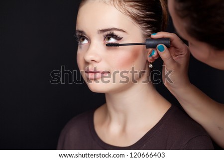 Make up artist applying make up to a fashion model