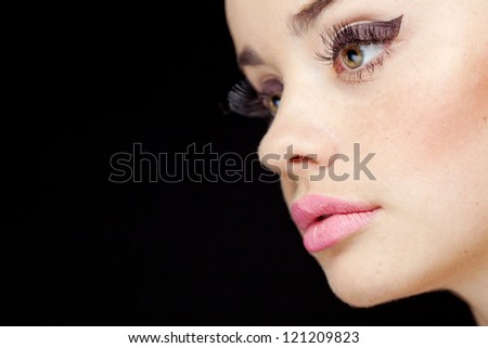 Glamourous closeup female portrait. Fashion evening elegance eyeliner makeup on model eyes. Cosmetics and make-up