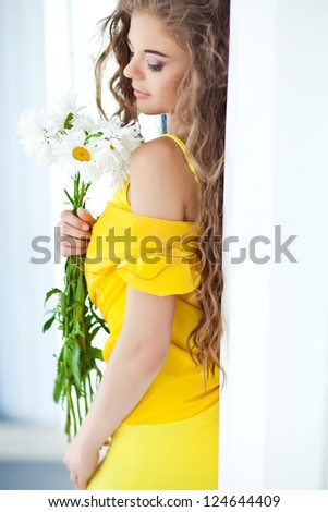 Portrait of happy smiling beautiful young woman with bouquet flowers