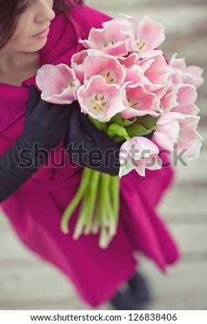 Beauty brunette with bunch of flowers