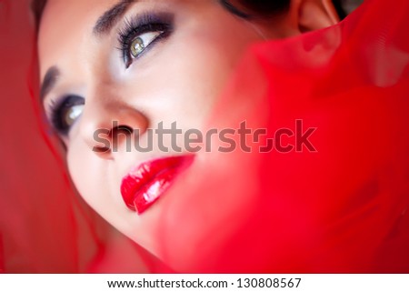 Photo of beautiful sexy woman with red  hat on the head isolated on black background, closeup portrait of seductive woman with perfect makeup,  beauty salon, fashion style