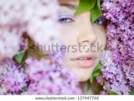 Portrait of a beautiful girl with flowers. Flower