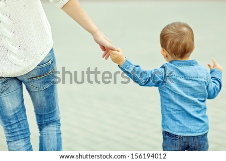 Mother and son holding hand in hand