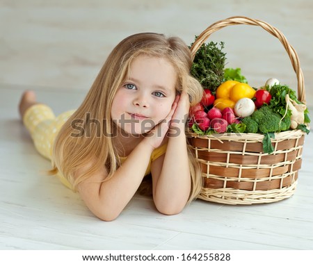 Gardening, vegetables - lovely girl with the basket of ecological harvests