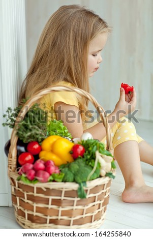 Gardening, vegetables - lovely girl with the basket of ecological harvests