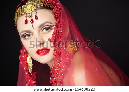 Beautiful young indian woman bellydancer n traditional clothing with bridal makeup and jewelry. gorgeous brunette bride traditionally dressed  India.
