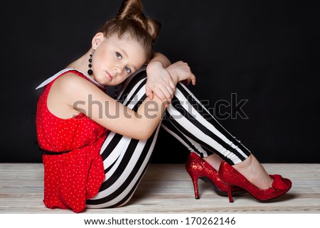 Little girl wearing her mother\'s shoes