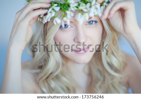 Beautiful woman with delicate flowers in her hair