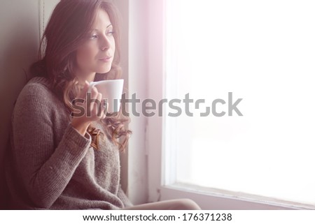 Portrait of happy brunette with mug in hands