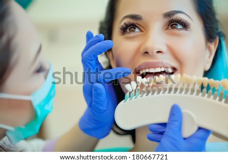 smiling woman with palette for tooth color smiling woman with palette for tooth color