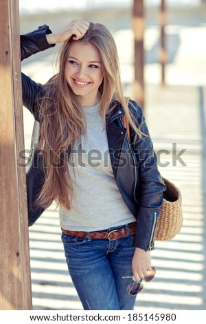 glamorous portrait of young beautiful woman in a leather jacket