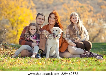 Happy family with dog on nature