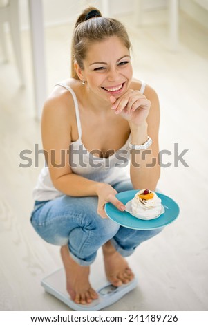 Beautiful woman with weights and food