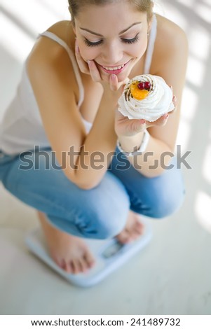 Beautiful woman with weights and food