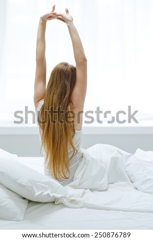 young woman sleeping on the white linen in bed at home
