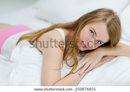 young woman sleeping on the white linen in bed at home