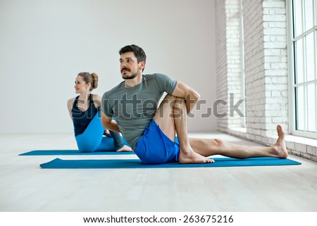 Young healthy couple in yoga position