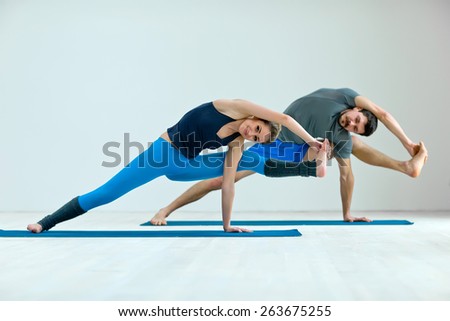 Young healthy couple in yoga position