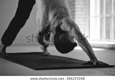 Man practicing yoga black and white photo