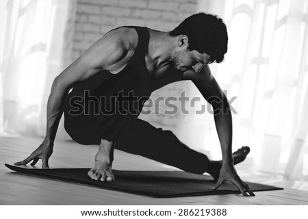 Man practicing yoga black and white photo
