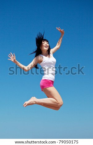 Young beautiful girl doing gymnastick jump