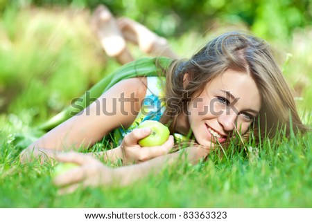 Bright  portrait of happy healthy woman holding apple