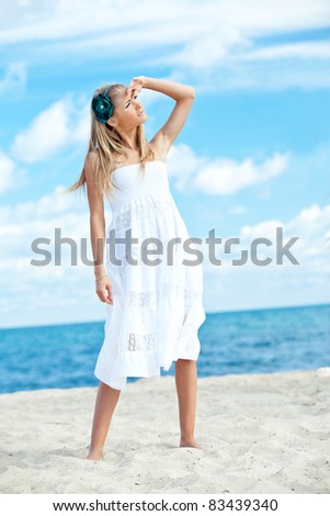 A beautiful woman   facing the sea on a vacant beach in paradise