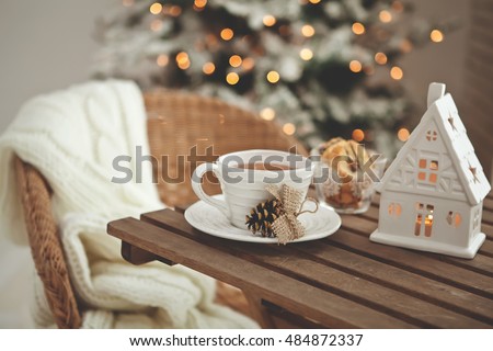 Christmas or new year decoration on modern wooden coffee table.  Living room interior and holiday home decor concept. Toned picture