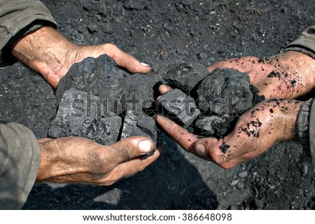 coal miner in the hands of coal background