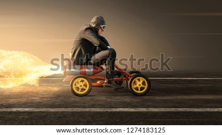 Man on a rocket pedal car