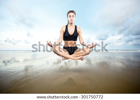 Meditating woman floats over the shore
