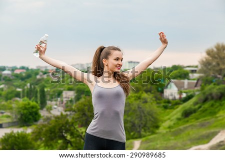 Athlete woman refreshing with Bottle of water after running workout outdoors. Woman Enjoying nature, Healthy active Lifestyle
