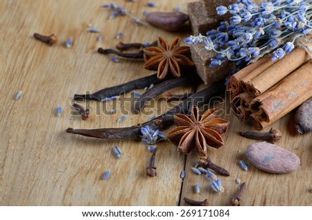 Vanilla, cinnamon, cocoa, anise and cloves on wooden table