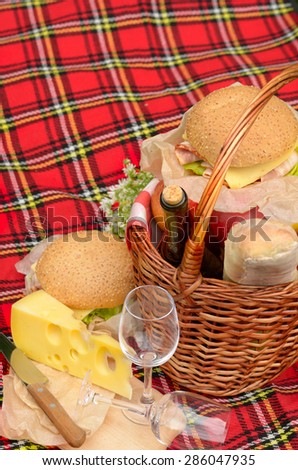 Picnic basket with apples bread cheese wine and sandwiches