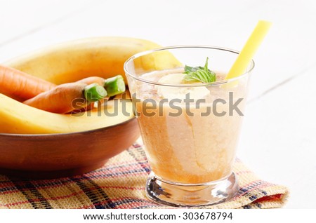 Carrot and banana shake on white table. Smoothie concept