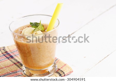 Carrot and banana shake on white table. Smoothie concept