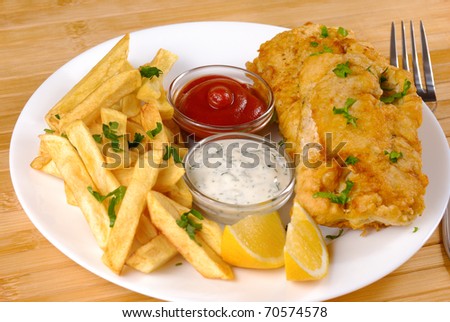 White plate with Fish and chips, mayo and ketchup